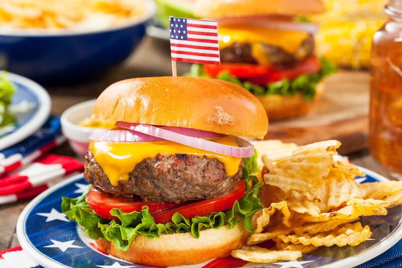 Burger and Fries on a Plate outside.
